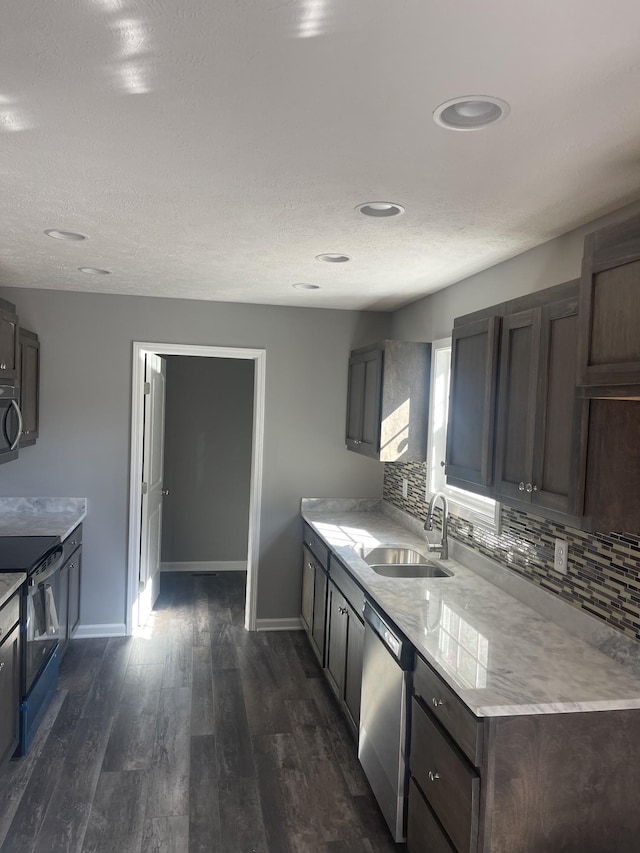 kitchen featuring a sink, stainless steel dishwasher, electric range oven, tasteful backsplash, and black microwave