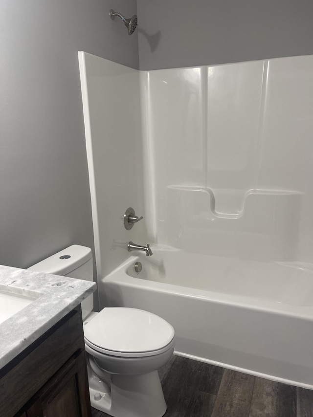 full bathroom featuring shower / bathing tub combination, vanity, toilet, and wood finished floors