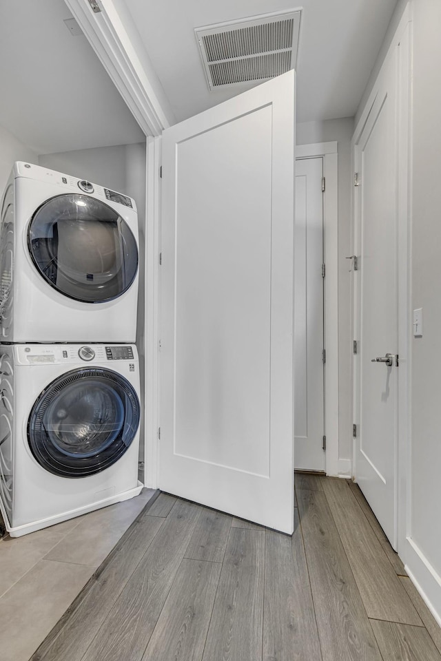 laundry area with stacked washer and clothes dryer