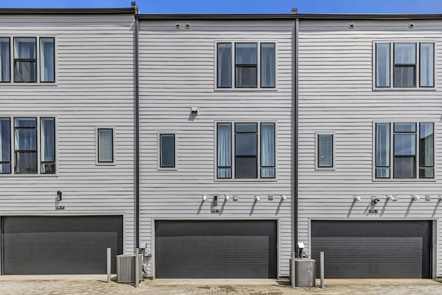 exterior space featuring a garage and central air condition unit