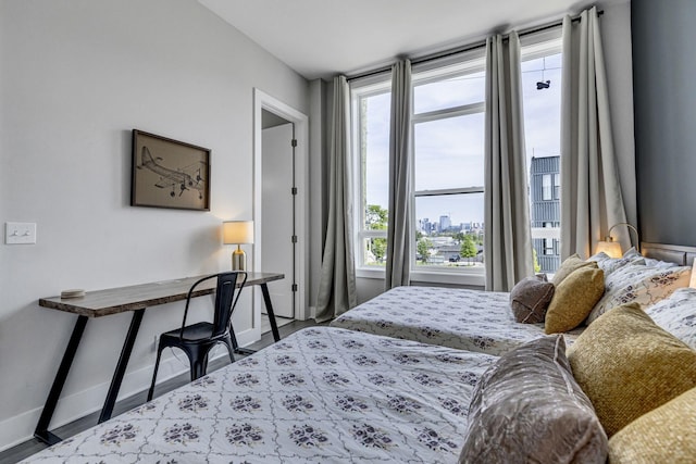 bedroom featuring hardwood / wood-style flooring and multiple windows