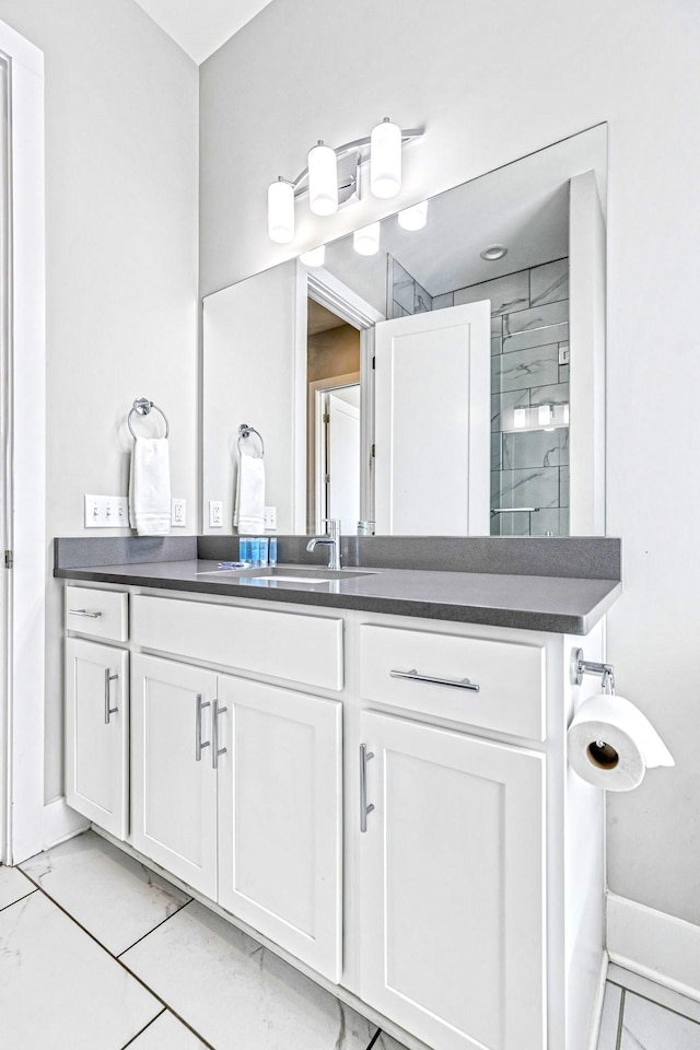 bathroom featuring vanity and tiled shower