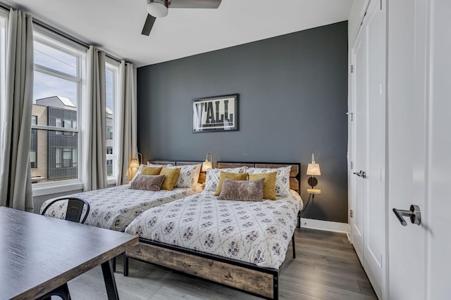 bedroom with ceiling fan and dark hardwood / wood-style floors