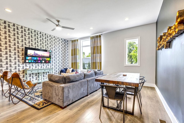 living room with ceiling fan and light hardwood / wood-style floors