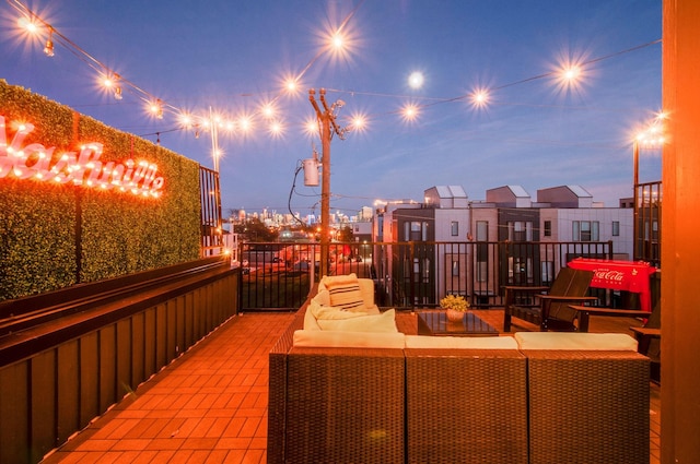 patio terrace at dusk featuring an outdoor living space