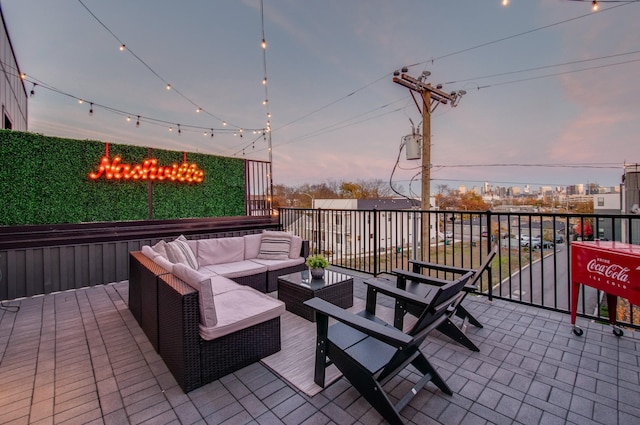 patio terrace at dusk featuring outdoor lounge area