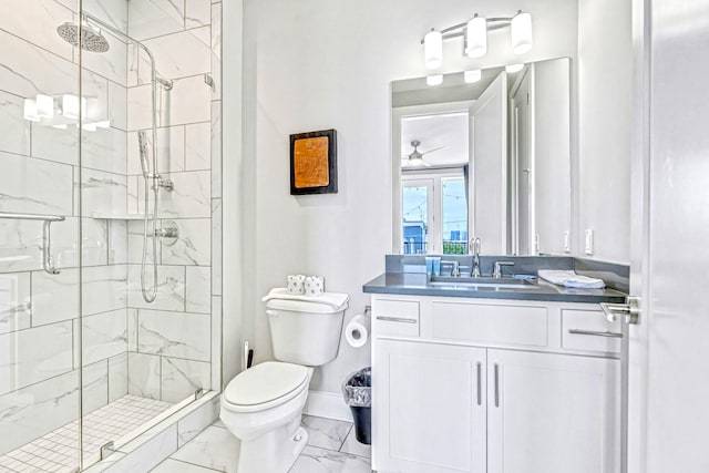 bathroom featuring vanity, ceiling fan, toilet, and a shower with shower door