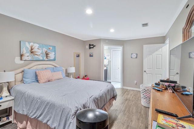 bedroom featuring wood-type flooring and ornamental molding