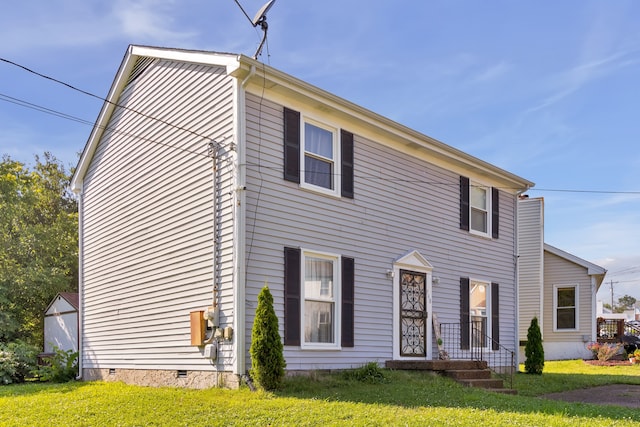 colonial home with a front lawn