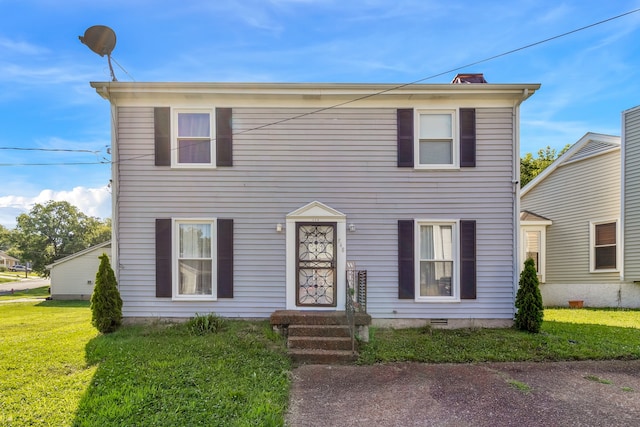 colonial-style house with a front lawn