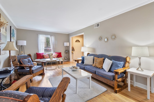 living room featuring light hardwood / wood-style flooring and crown molding