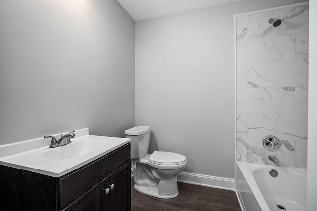 full bathroom featuring vanity, wood-type flooring, tiled shower / bath combo, and toilet