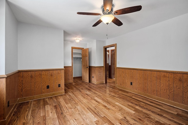 empty room featuring wood-type flooring and ceiling fan