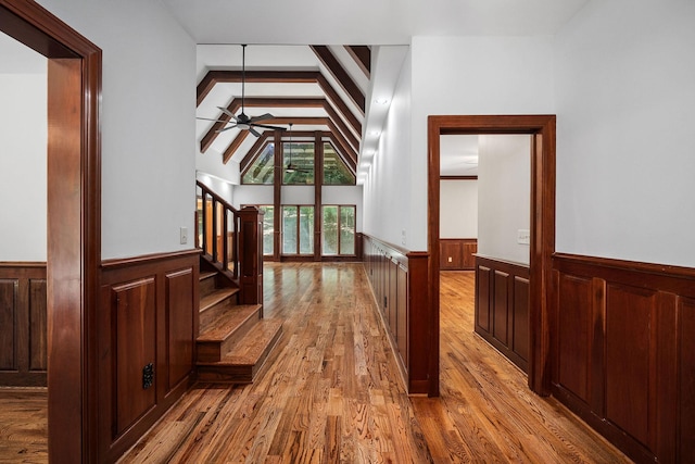 hallway featuring light hardwood / wood-style floors and vaulted ceiling