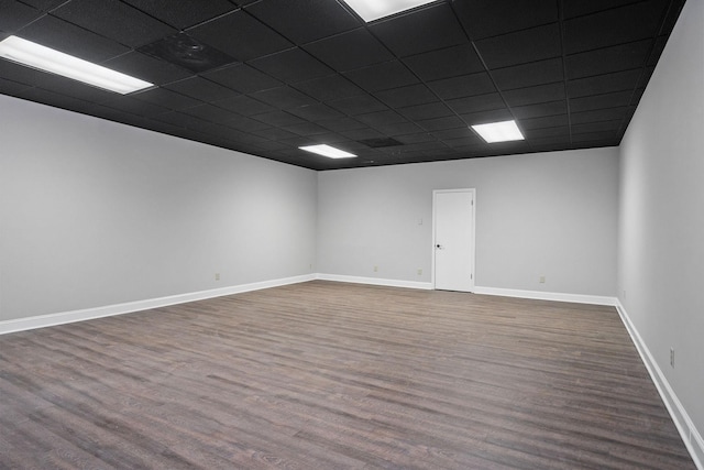 unfurnished room with a paneled ceiling and hardwood / wood-style flooring