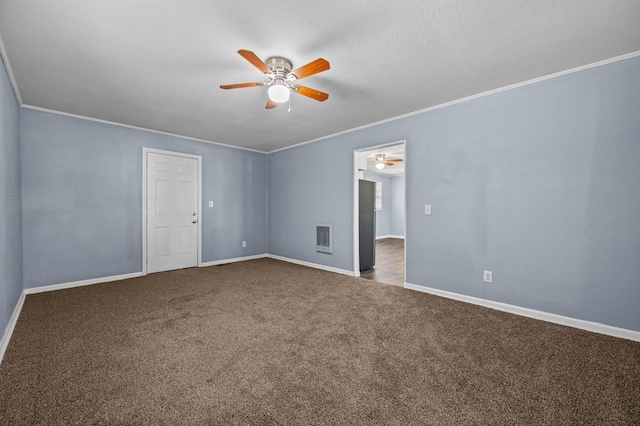 unfurnished room featuring a textured ceiling, carpet floors, and crown molding