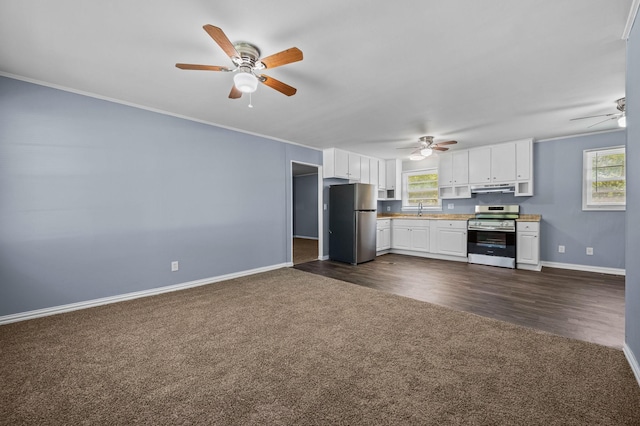 kitchen featuring white cabinetry, plenty of natural light, stainless steel appliances, and dark colored carpet