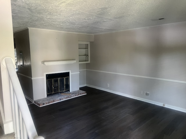 unfurnished living room featuring a textured ceiling, dark hardwood / wood-style floors, and crown molding