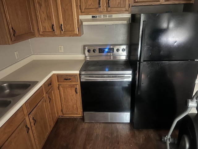 3251 Anderson Rd NE, Antioch, TN 37013 - kitchen featuring stainless steel electric stove, freestanding refrigerator, under cabinet range hood, and brown cabinetry