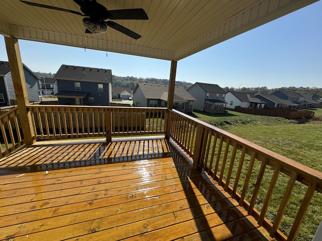 wooden deck with a yard and ceiling fan