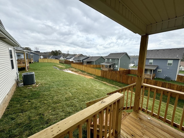 exterior space with central AC unit and a lawn