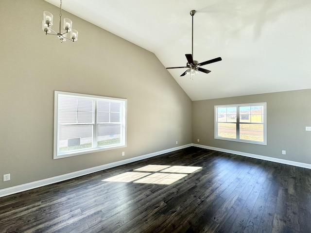 spare room with lofted ceiling, dark wood-type flooring, and ceiling fan with notable chandelier