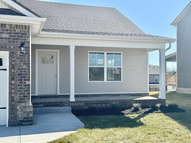 property entrance with a yard and a porch