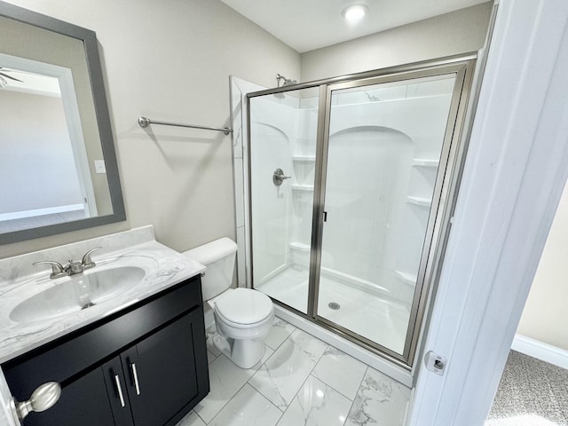 bathroom with vanity, a shower with door, and toilet