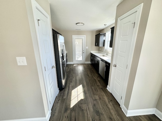 kitchen with dark hardwood / wood-style flooring, sink, pendant lighting, and appliances with stainless steel finishes