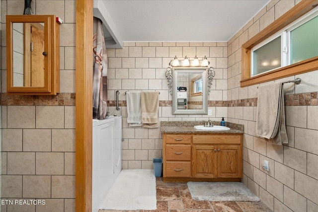 bathroom featuring vanity with extensive cabinet space, tile walls, and tile floors