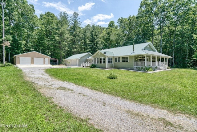 ranch-style home featuring a front lawn, a garage, an outdoor structure, and a porch