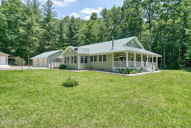 view of front facade with covered porch, an outdoor structure, a garage, and a front lawn