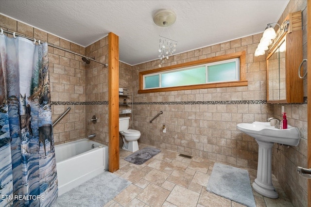 bathroom with tile floors, shower / bath combination with curtain, toilet, and tile walls