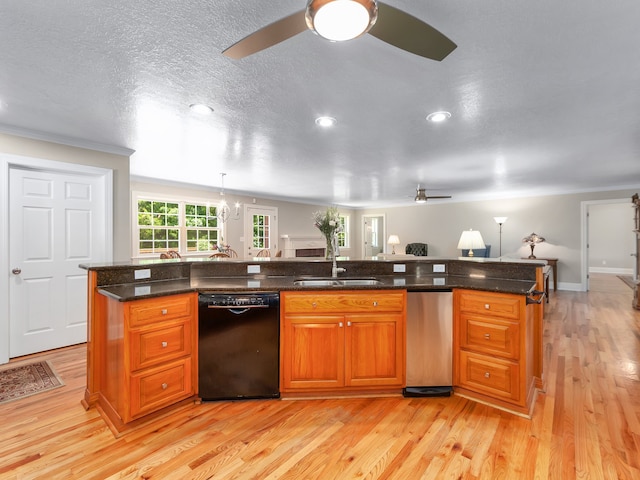 kitchen with ceiling fan, stainless steel dishwasher, a center island with sink, dishwasher, and light wood-type flooring