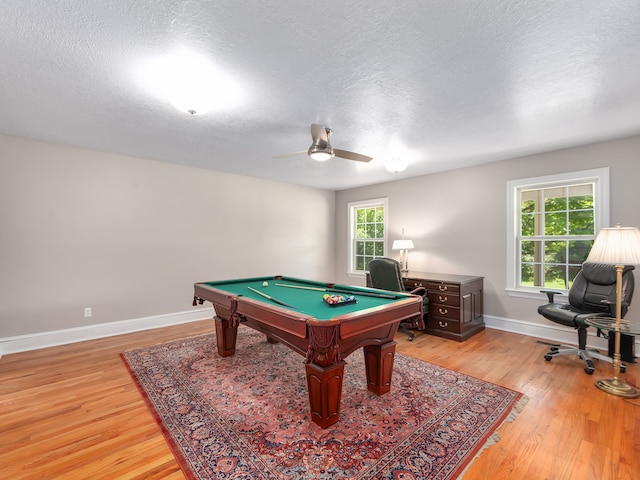 game room featuring light hardwood / wood-style floors, a textured ceiling, billiards, and ceiling fan