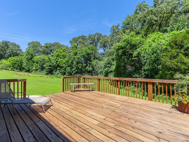 wooden terrace featuring a yard