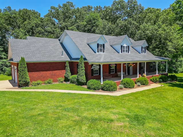 cape cod-style house featuring a front lawn and a porch