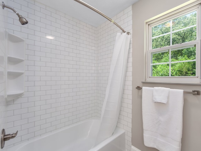 bathroom featuring shower / tub combo with curtain