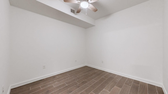 spare room featuring ceiling fan and dark hardwood / wood-style floors