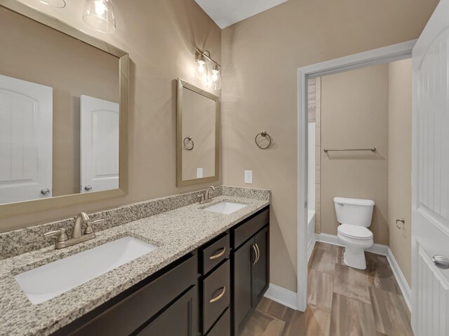 full bathroom with vanity,  shower combination, toilet, and radiator heating unit