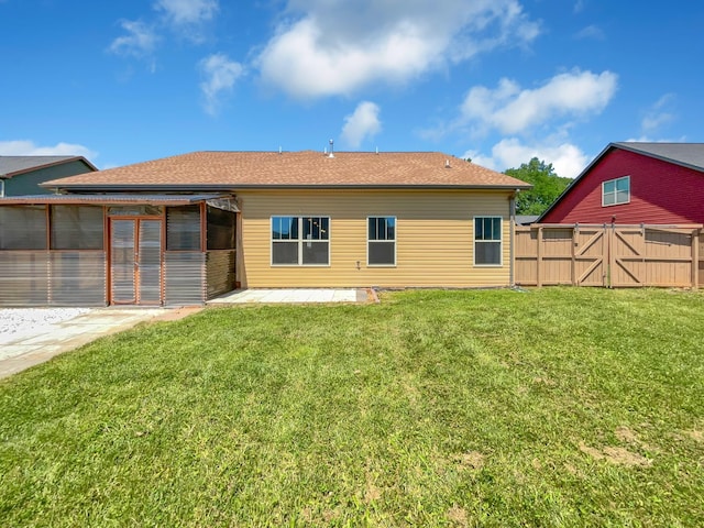 rear view of house featuring a lawn and a patio area