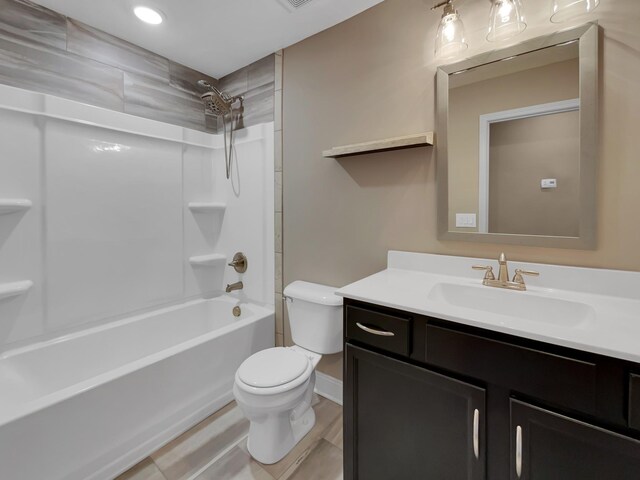 full bathroom featuring hardwood / wood-style flooring, vanity, toilet, and bathtub / shower combination