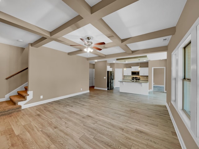 unfurnished living room with beamed ceiling, ceiling fan, light hardwood / wood-style floors, and coffered ceiling