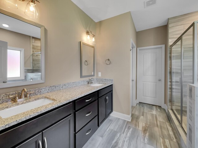 bathroom with vanity and a shower with shower door