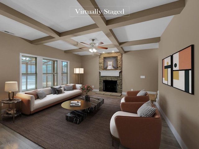 living room featuring beamed ceiling, a stone fireplace, dark wood-type flooring, and coffered ceiling