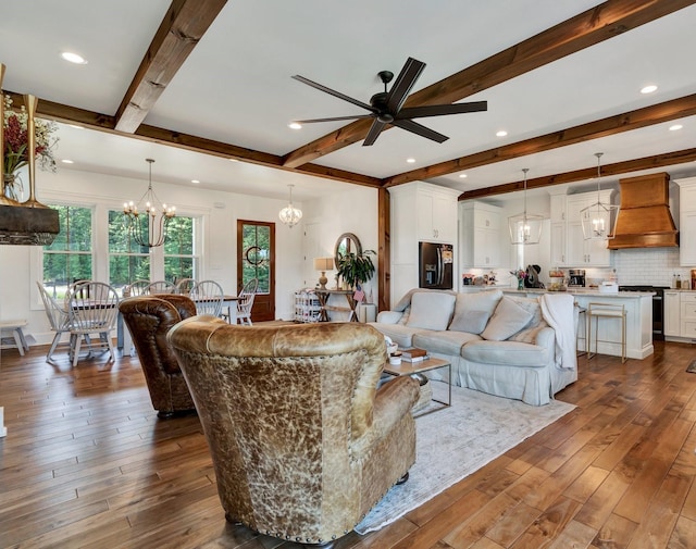 living room featuring beam ceiling, ceiling fan with notable chandelier, and dark hardwood / wood-style floors