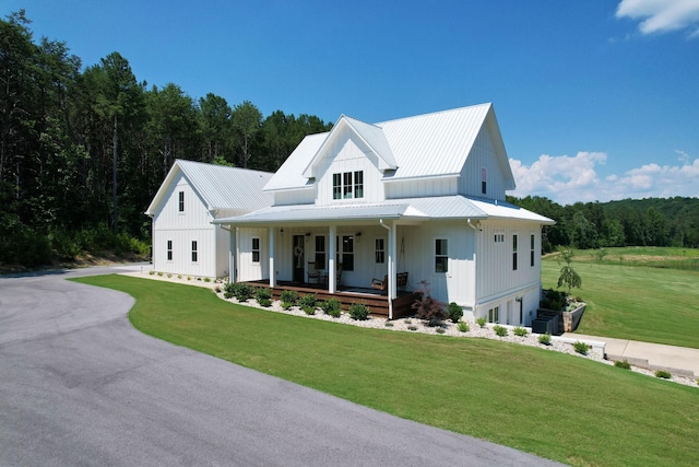 modern farmhouse featuring a front lawn and a porch