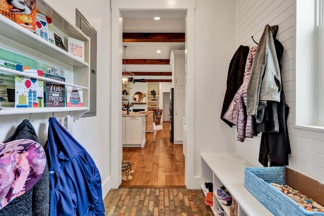 mudroom featuring beam ceiling and dark hardwood / wood-style floors