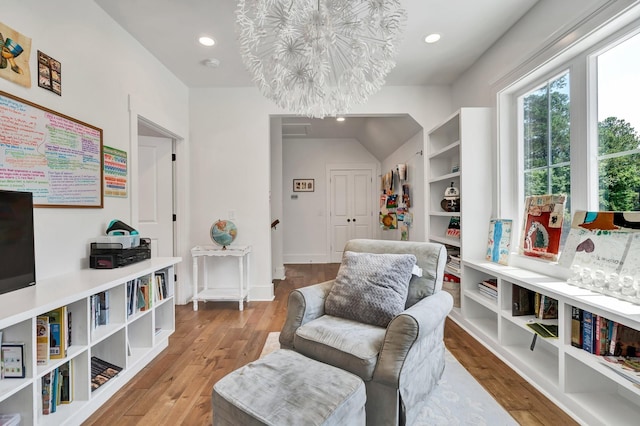 living area featuring a chandelier and hardwood / wood-style flooring