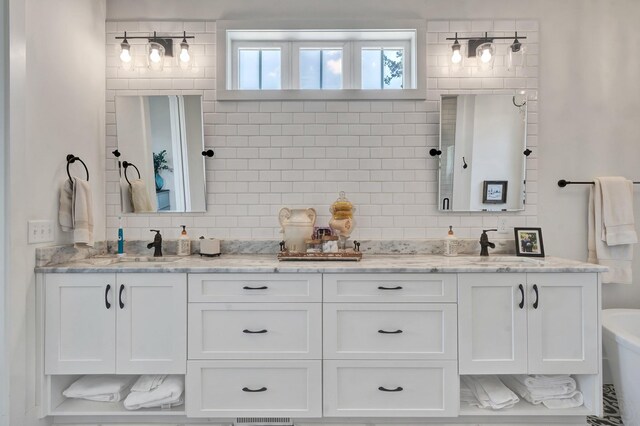 bathroom with decorative backsplash, vanity, and a bath